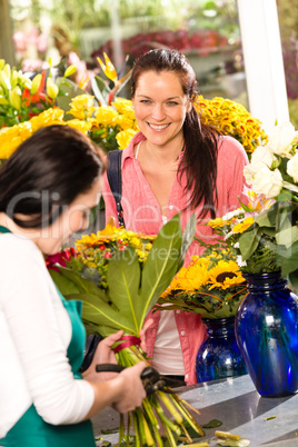 Cheerful woman buying bouquet flower shop florist