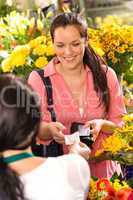 Woman customer taking receipt flower shop buying