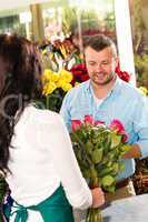 Husband buying roses bouquet romantic flower market