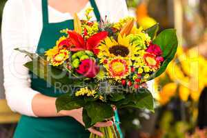 Florist holding bouquet colorful flowers shop assistant