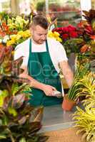 Florist man reading barcode potted plant shop