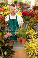 Young man scanning barcode flower shop gardening