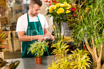 Man florist reading price barcode reader flower