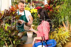 Man selling pot woman customer flower shop