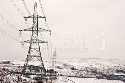 Electricity pylons on snow covered moors