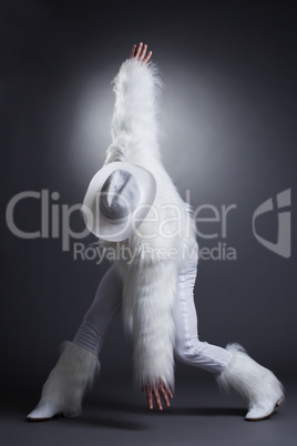 Sexy striptease dancer in white fur costume