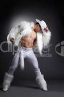Athletic striptease dancer in white cowboy costume