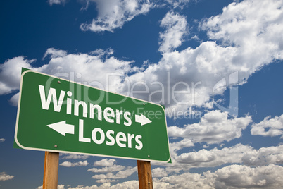 Winners, Losers Green Road Sign Over Clouds