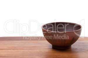 Empty ceramic bowl on wooden kitchen table