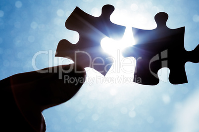 Hand holding jigsaw pieces