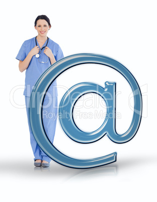 Nurse in scrubs standing beside email at symbol