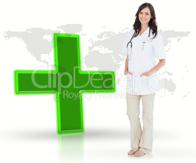 Nurse standing by digital green cross