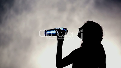 Silhouette of a Woman Drinking Water