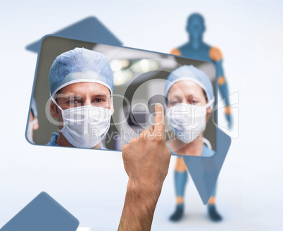 Hand selecting image of surgeons from digital interface