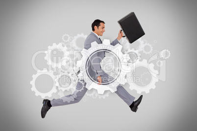 Businessman running with briefcase on grey background