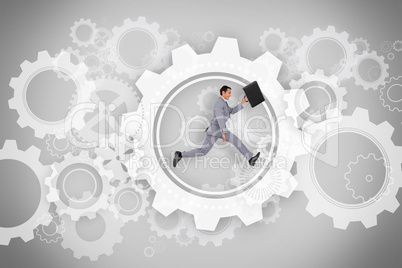 Businessman running with briefcase with wheels and cogs graphic