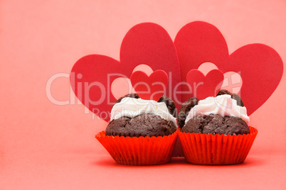 Two valentines cupcakes with four heart decorations