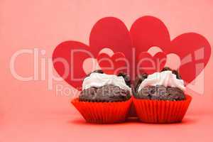 Two valentines cupcakes with four heart decorations