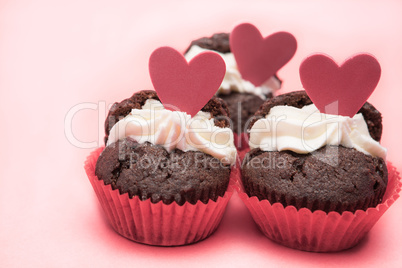 Three chocolate valentines cupcake with heart decorations