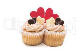 Two valentines cupcakes with heart decorations