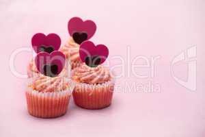 Four valentines muffins with heart decorations