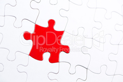 White jigsaw puzzle with one red piece