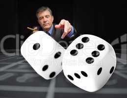 Gambler at the poker table with digital dice in foreground