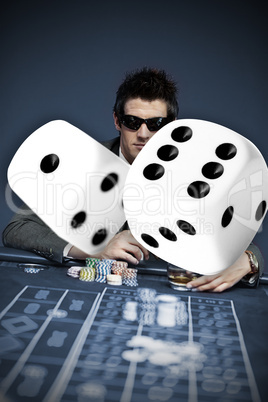 Gambler in sunglasses with digital dice in foreground