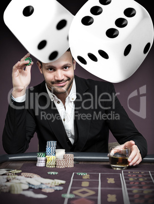 Handsome gambler with digital dice