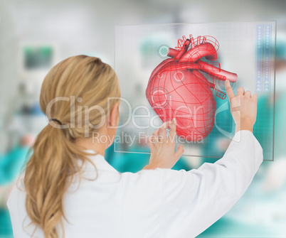 Doctor consulting touchscreen displaying heart diagram