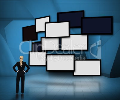 Group of blank screens on blue background with businesswoman loo