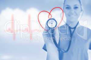 Happy nurse holding up stethoscope to heart design in blue tint