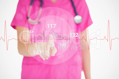 Nurse in pink scrubs touching red ECG line with figures