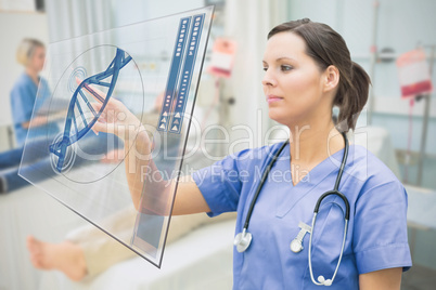 Nurse touching screen showing blue DNA helix data
