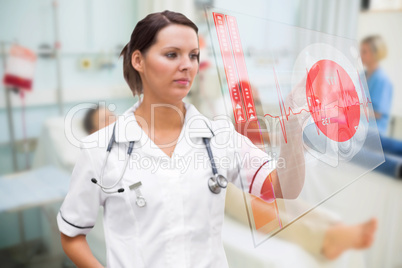 Nurse pressing screen showing red ECG data