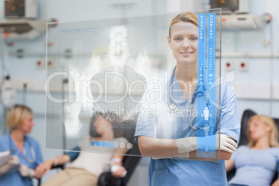 Smiling nurse standing behind blue display screen showing x-ray
