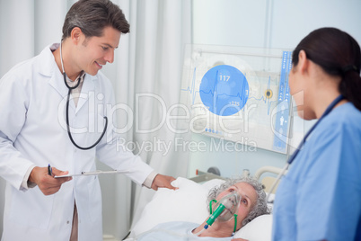 Doctor and nurse checking patient lying under digital screen sho