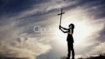 Silhouette of Woman With Cross