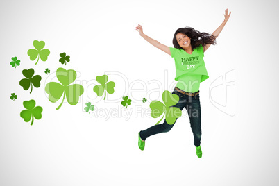 Girl wearing patricks day t-shirt jumping for joy