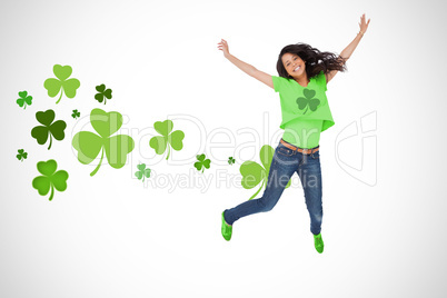 Girl wearing green shamrock t-shirt jumping for joy