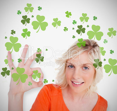 Blonde giving ok symbol for st patricks day and smiling