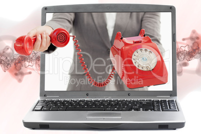 Woman reaching out from laptop handing phone receiver