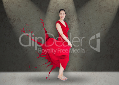 Happy asian woman with red dress turning to paint splatter on st