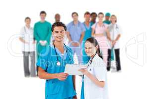 Nurse and doctor holding clipboard and smiling