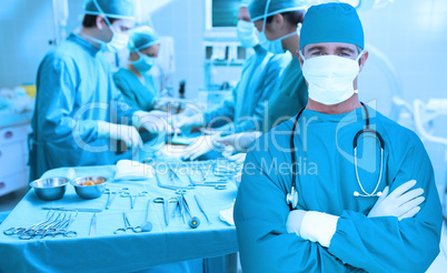 Surgeon standing with arms crossed