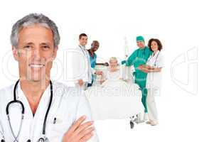 Smiling doctor with patient in bed and medical staff behind him