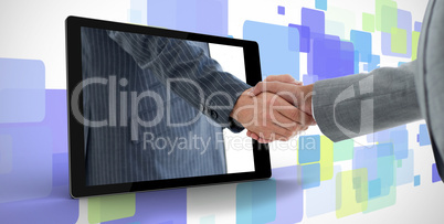 Businessman reaching out from tablet and shaking hands with othe