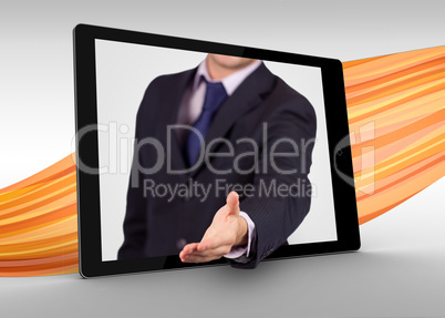 Businessman reaching out from tablet to shake hands