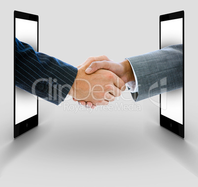 Businessmen shaking hands from digital tablets