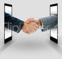 Businessmen shaking hands from digital tablets